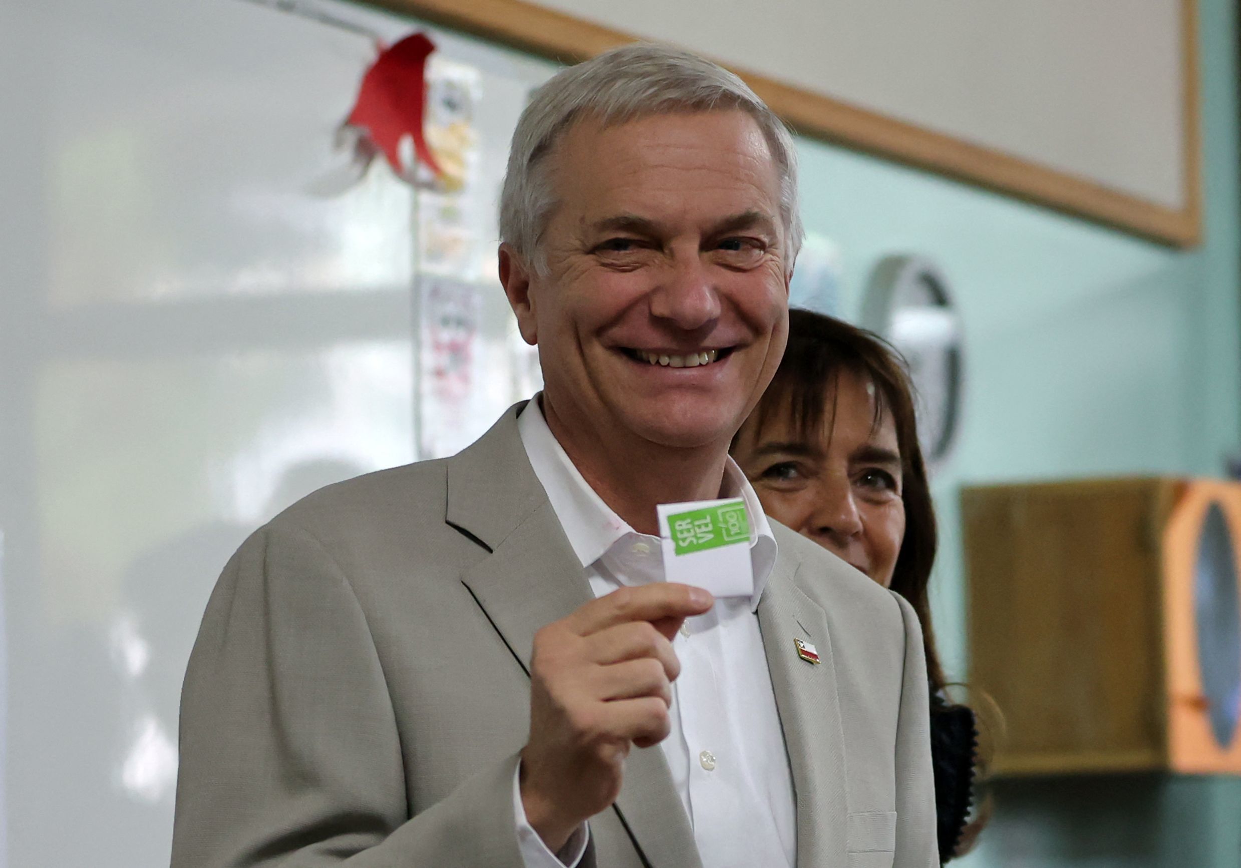 Chile's presidential candidate Jose Antonio Kast, of the Partido Republicano party, poses for a picture with his wife Maria Pia Adriasola before casting his ballot during the presidential runoff election in Paine, south of Santiago, on December 14, 2025. Chileans head to the polls for a presidential runoff between Jeannette Jara, a communist backed by a broad left coalition, and Jose Antonio Kast, a devout far-right politico promising a hard line on security and migration. (Photo by Javier TORRES / AFP)